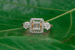 Baguette and Round Diamond Ring with Halo Frame Design